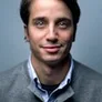 Portrait of Marco Velez in a casual office environment.