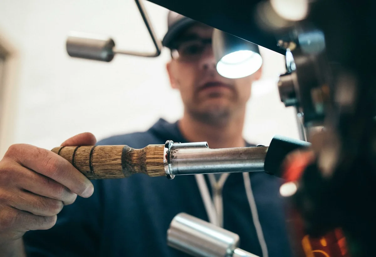 Licensed plumber repairing pipework in a workshop