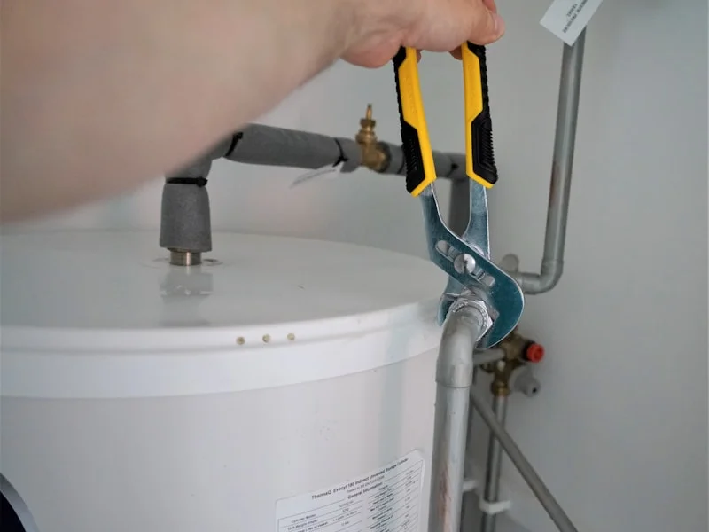 Technician installing plumbing fixtures